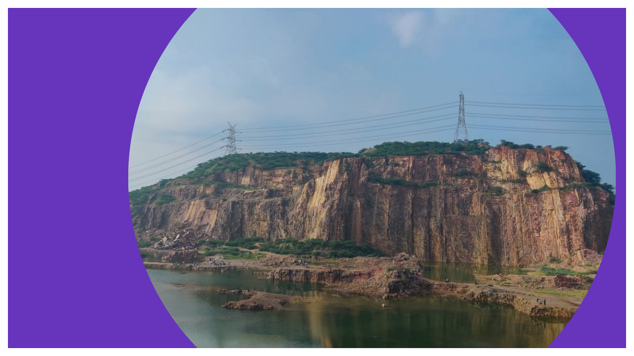 Calm lake surrounded by Aravalli hills, one of the easy places to visit near delhi under 50 km for a quick day trip