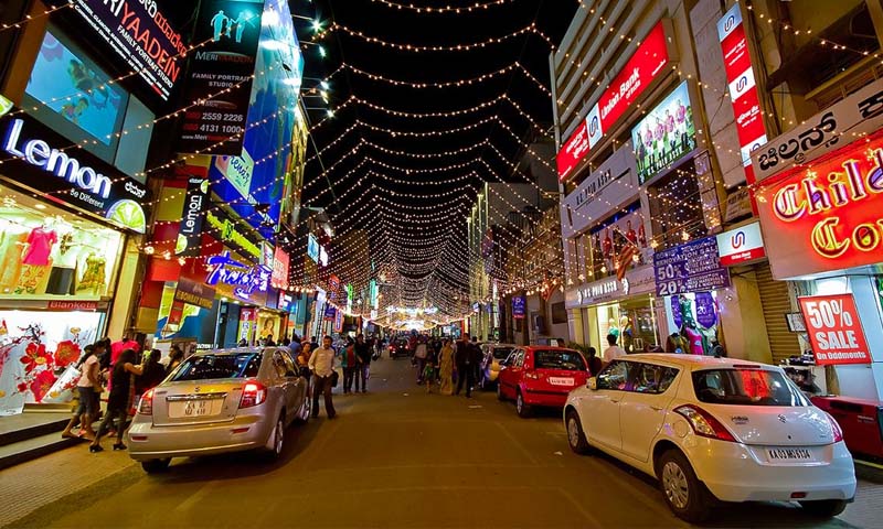 Commercial Street Bangalore; busy shopping lanes with ethnic wear stores, jewellery shops, and footwear stalls in Shivaji Nagar