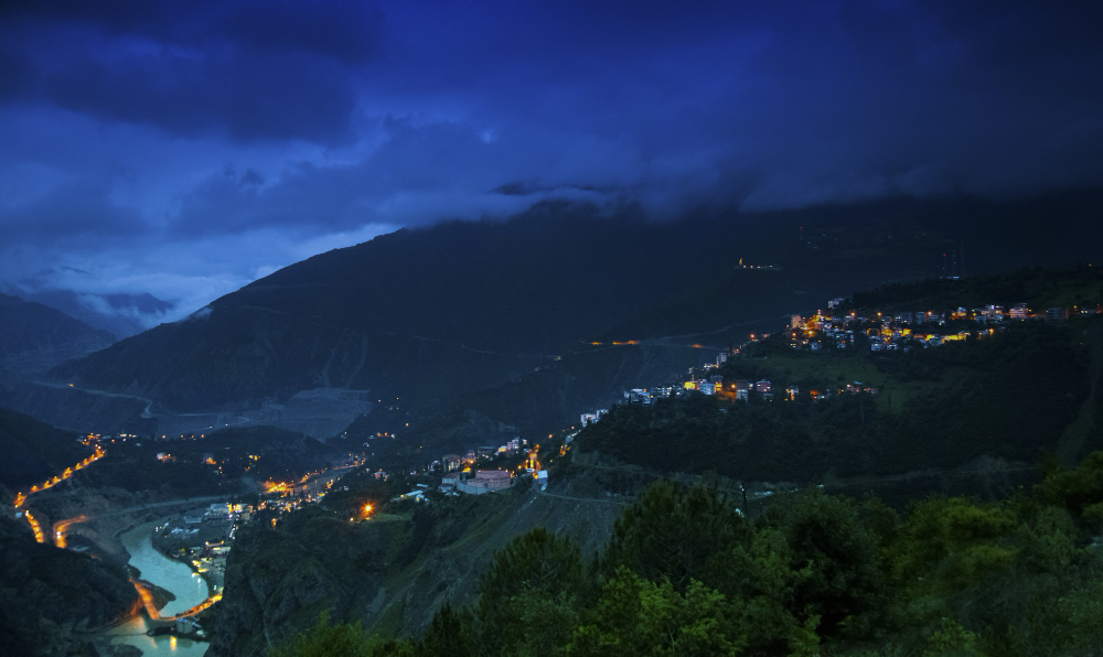 Places to visit near Dehradun under 100 km: Mussoorie's Mall Road in morning mist and Tiger Falls tumbling through dense forest in Chakrata