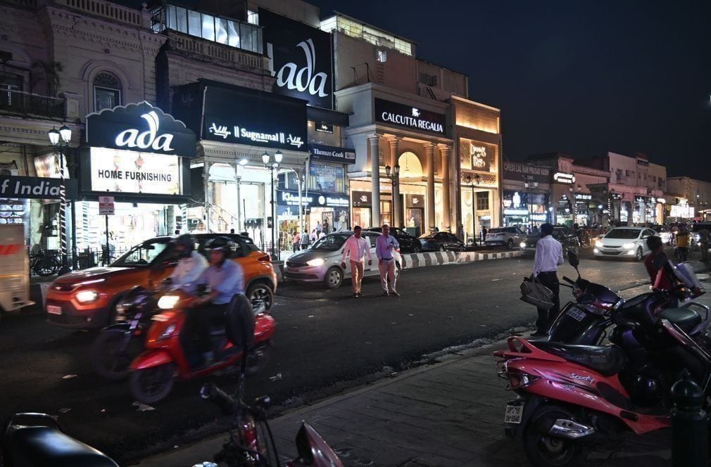 Victorian style lamp posts and pink cream shops along the main stretch of Hazratganj Lucknow showing hazratganj lucknow market timings and shopping scene