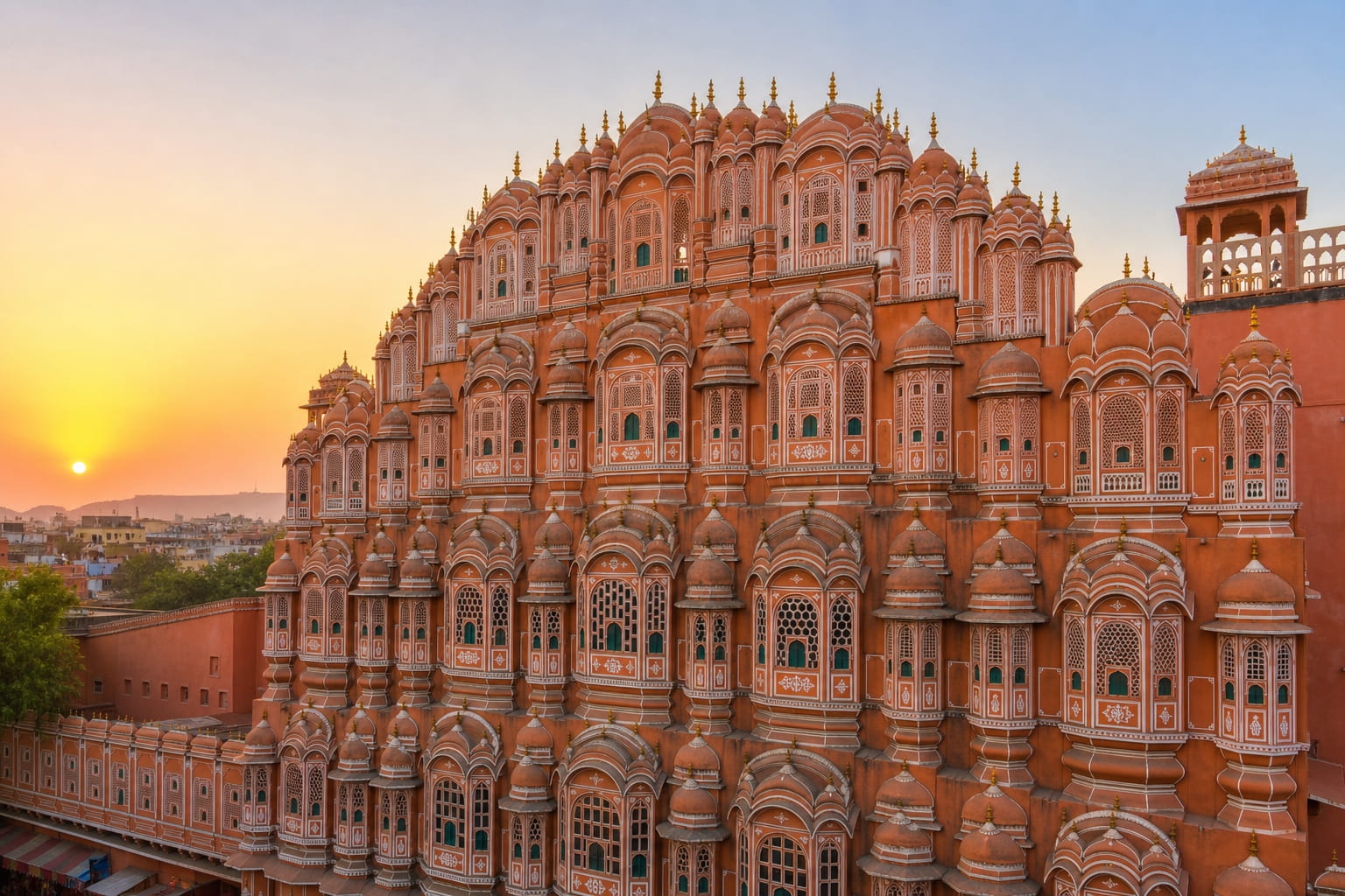 Pink sandstone facade of Hawa Mahal in Jaipur walled city at sunrise