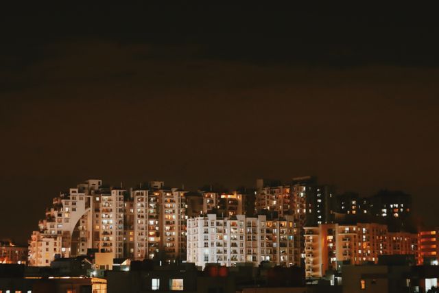 Nagpur city skyline at night with illuminated buildings reflecting urban life.
