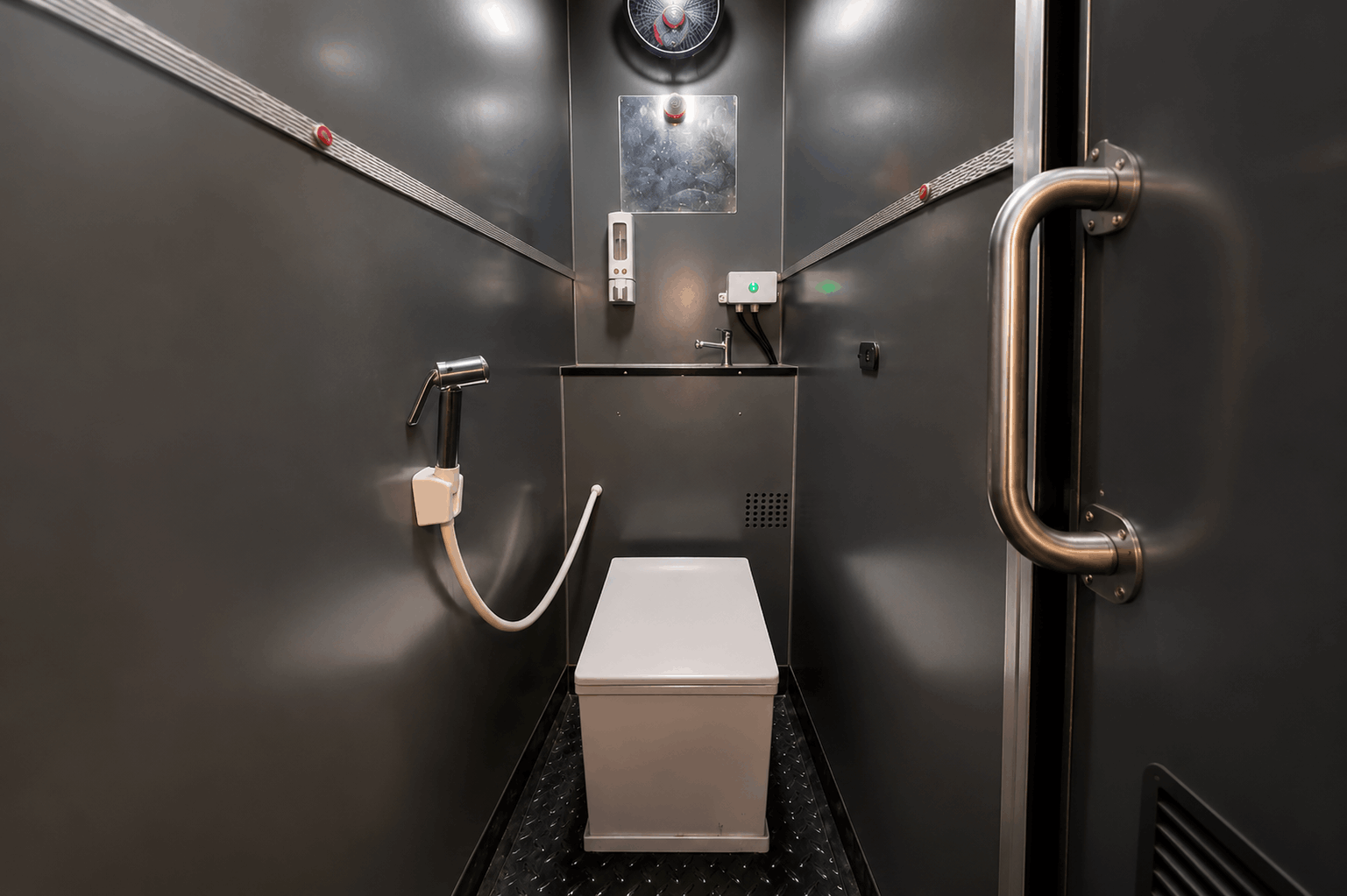 Clean and well-maintained bio-washroom interior inside a zingbus intercity coach with anti-skid flooring and handle bars