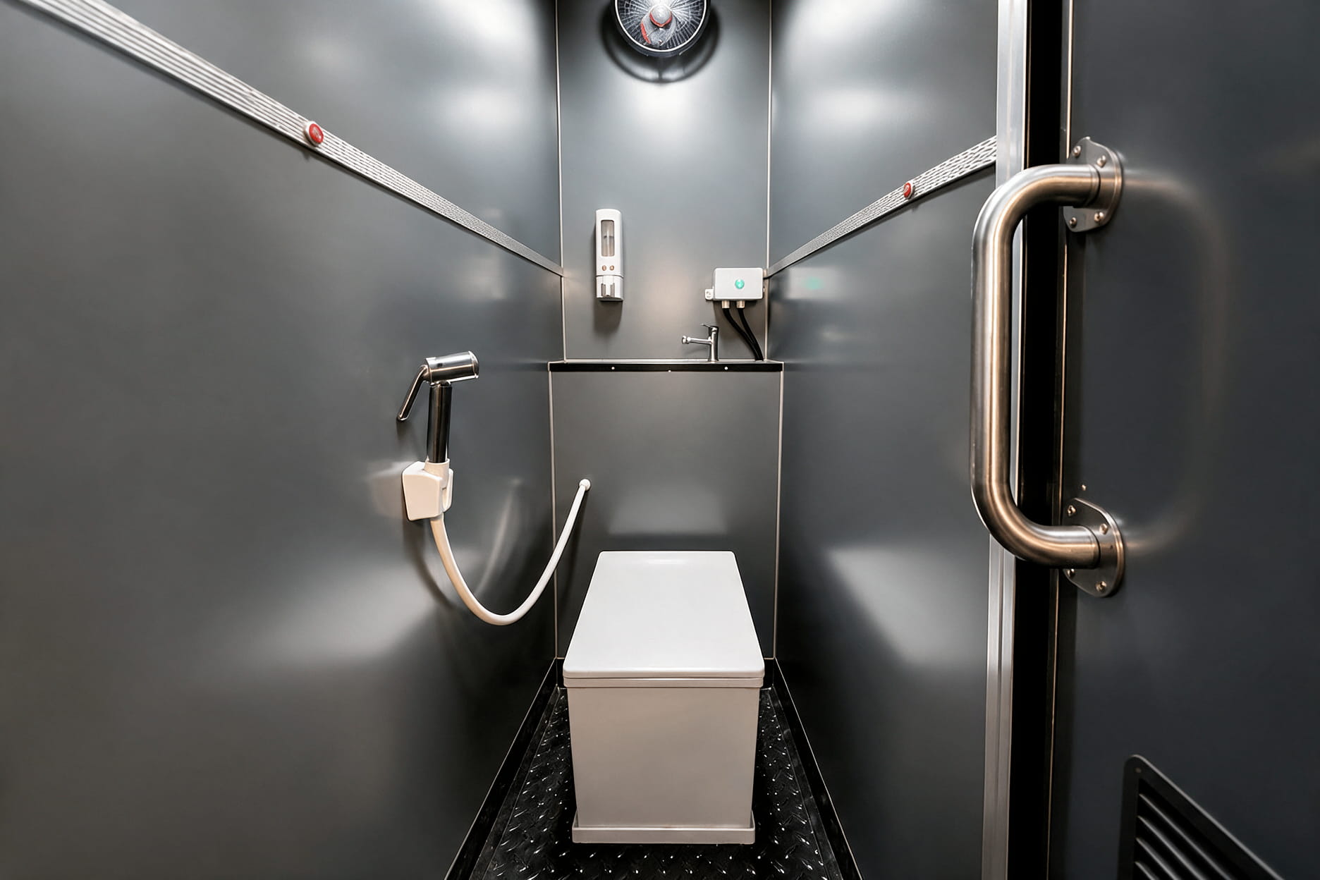 Clean and well-lit onboard bus washroom with handle bars and anti-skid flooring inside an intercity coach
