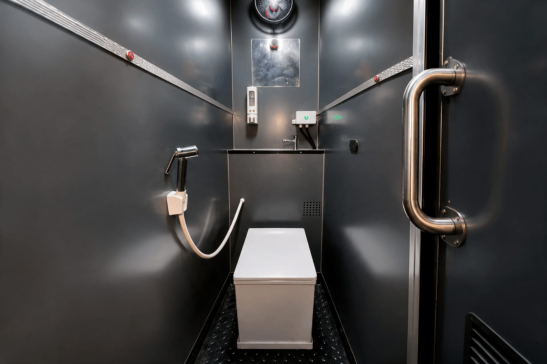 Clean onboard bus washroom with handle bars and anti-skid flooring inside a modern intercity coach