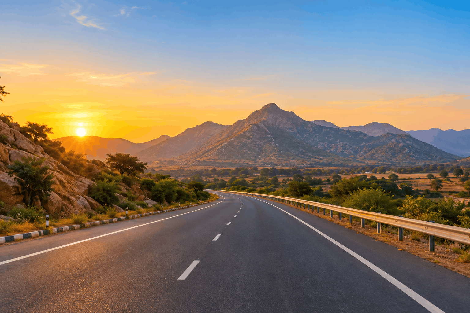 A highway stretching towards the Aravalli hills at sunrise with clear November skies